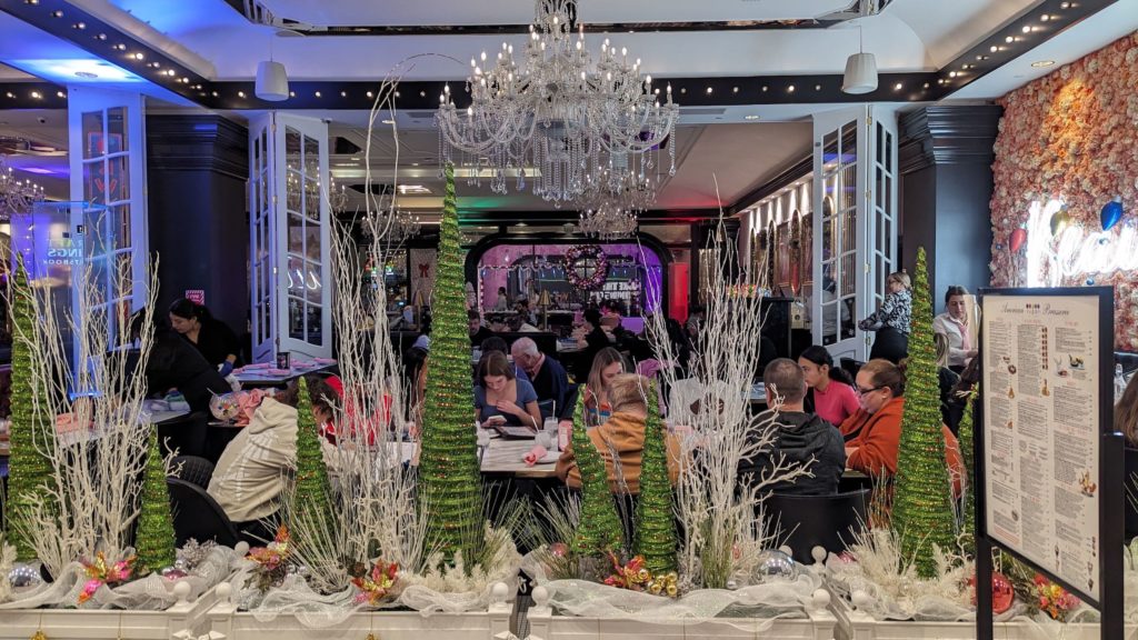 Famly having lunch at the Sugar Factory at the Foxwoods Casino, where dark gaming floors turn day into an immersive night.