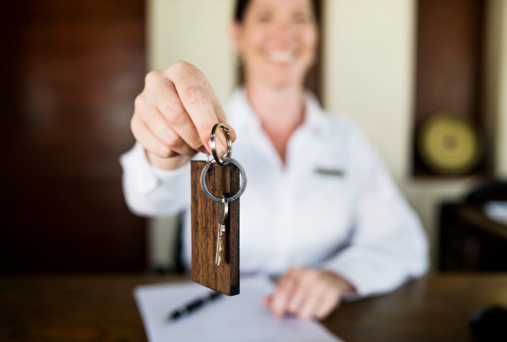 Close up of hotel key in a woman's hand.