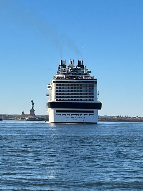 The MSC Meraviglia sails from her berth in Brooklyn past the State of Liberty. Photo c. Harvey Waldman
