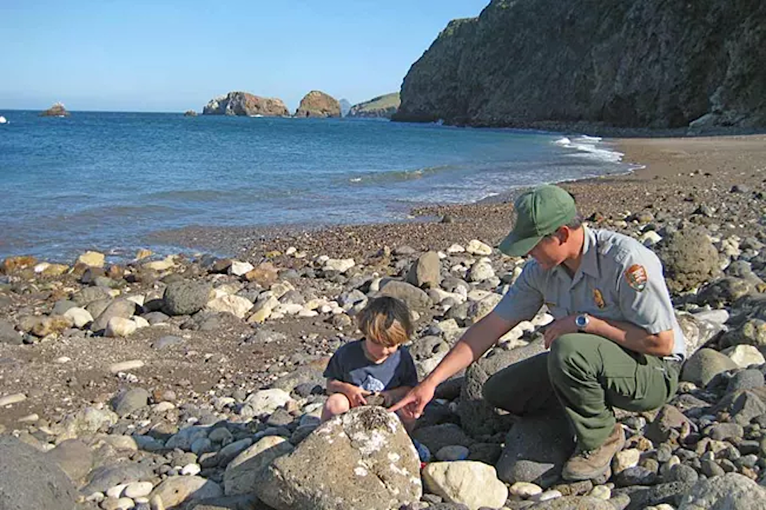 National Park Ranger explores shoreline at Channel Islands. Photo c. NPS