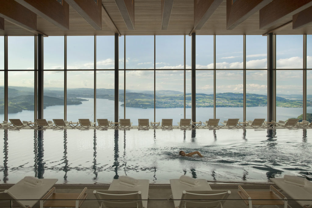 Spend your spring break vacation at the Indoor infinity pool overlooking Lake Lucerne and the Alps at the Burgenstock Alpine Resort & Spa. Photo c. Burgenstock Resort Lake Lucerne