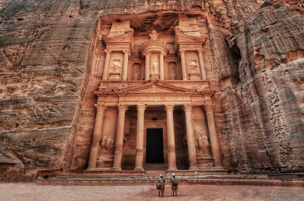 Tourists pose in ancient gladiator costumes outside the Treasury at Petra, one of Jordan's most famous adventure attractions. Photo c. unsplash