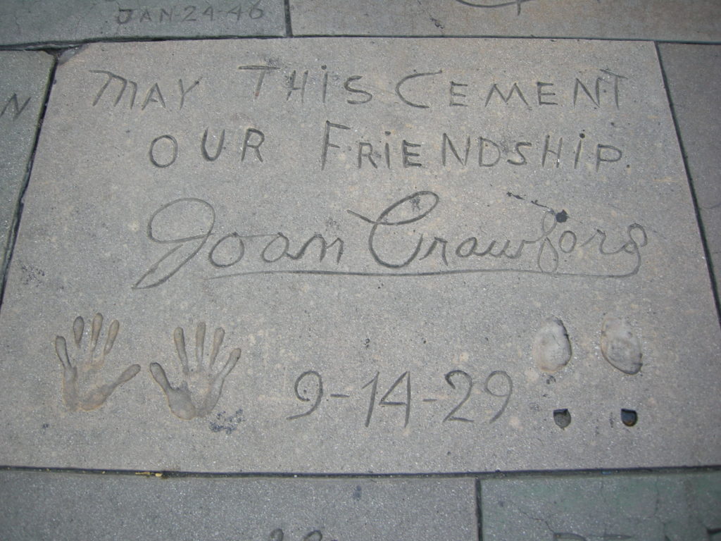 Joan Crawford's hands and tiny shoe prints at Grauman's Chinese Theatre. c. wikipedia. By I, Sailko, CC BY-SA 3.0, https://commons.wikimedia.org/w/index.php?curid=11825213