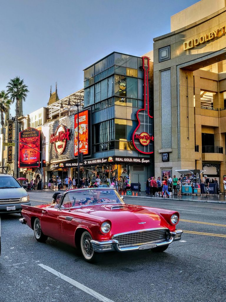Vintage red Corvette convertible tours Hollywood Boulevard in Los Angeles. Photo c. Benoit Debaix for unsplash