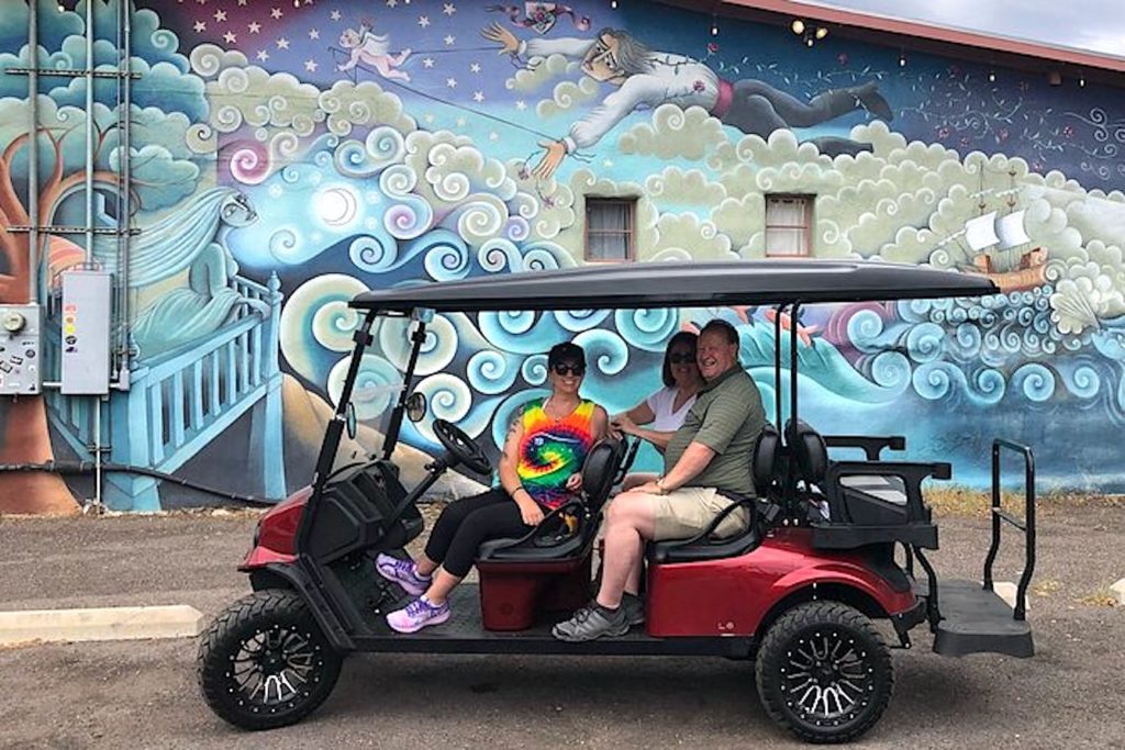 Guide and visitors in a golf cart in Bisbee, Arizona