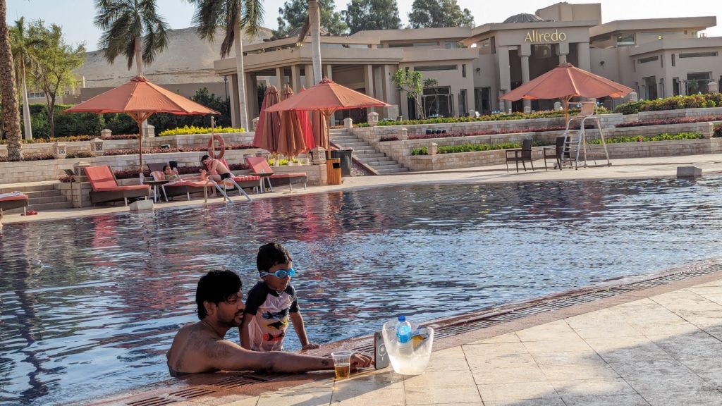 Father and son play by the side of the pool at the Marriott Mena House, Cairo.
