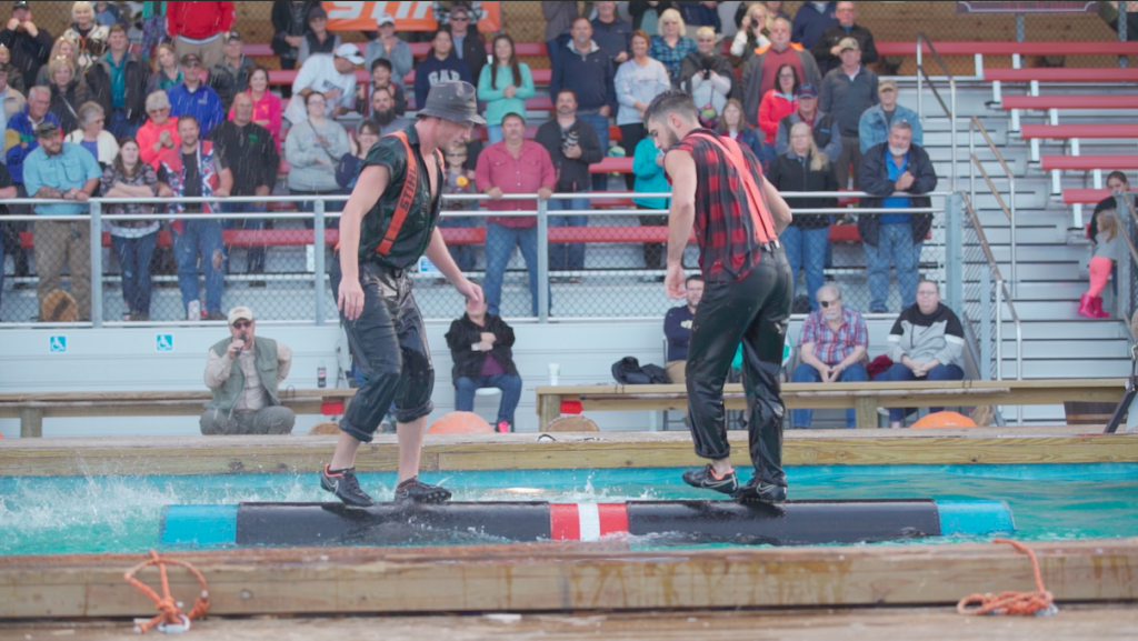 Two men rolling logs at Paula Deen's Lumberjack Feud Show in Pigeon Forge. Photo c. Pigeon Forge Dept of Tourism.