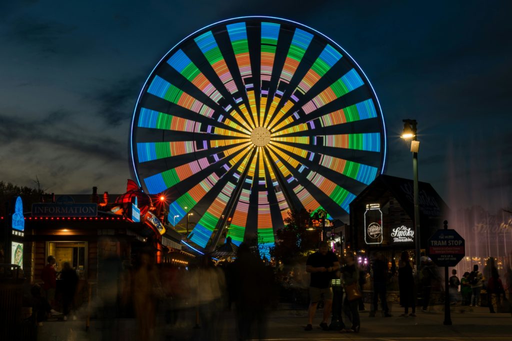 The colorful Great Smoky Mountain Wheel illuminated at night in Pigeon Forge, Tennessee. Photo c. Siva Seshappan for pexels