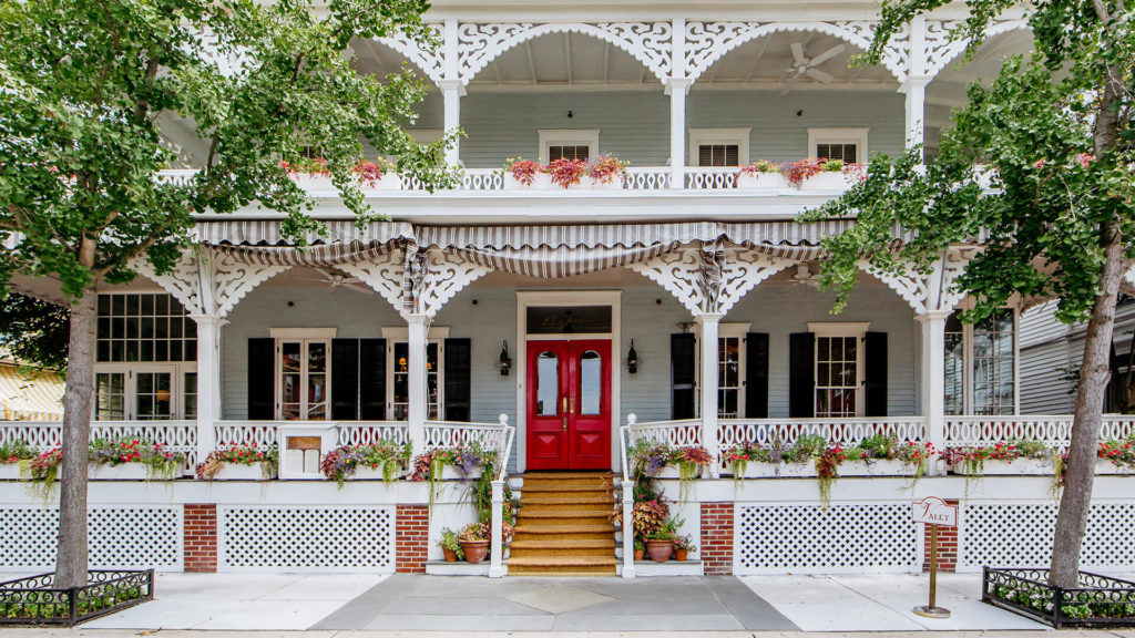 The Victorian style front porch and bright red door of the Virginia Hotel in Cape May, NJ. Photo c. Virginia Hotel