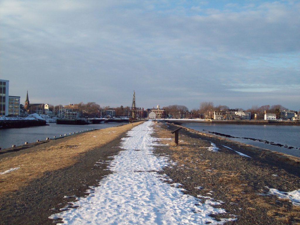 Snow covering the path out to the Long Wharf at the historic harbor of Salem, Massachusetts.