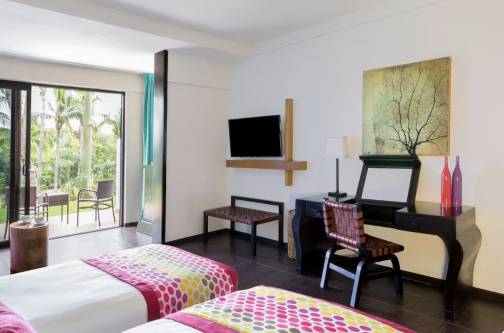 An Exclusive Collection garden view room at Club Med Cancun Yucatan exudes vibrant Mexican colors.