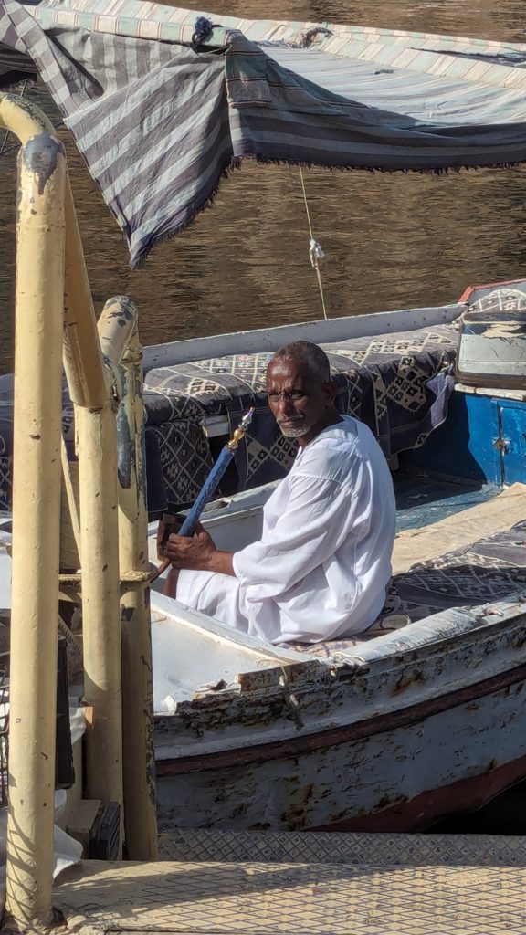 Felucca captain transports our group to Philae Island to see temples.