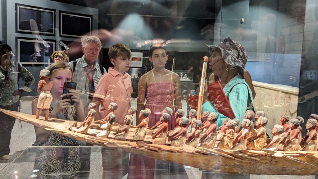 Guide Amira Hosny points out a model ship transporting the Pharaoh to the Afterlife at the Luxor Museum. 