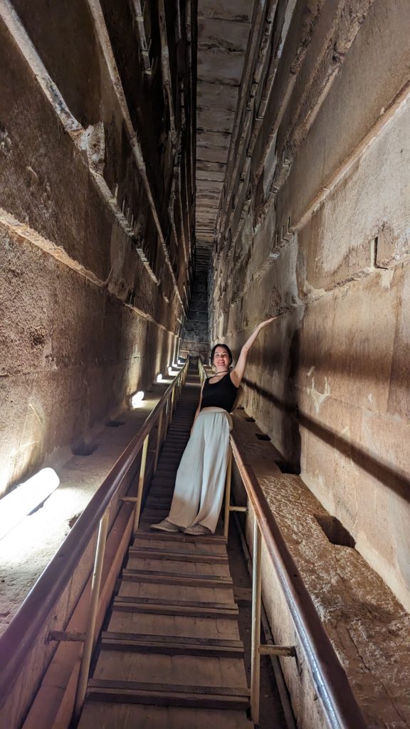 Visitor poses inside the passageway leading up to the sarcophagus of Pharaoh Khufu in the Great Pyramid. 