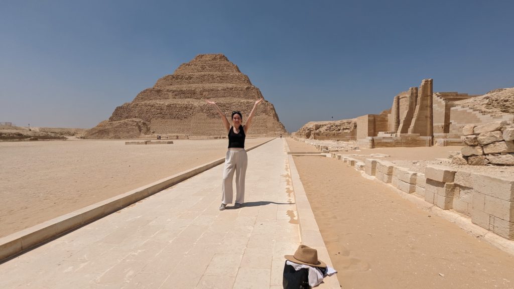 Girl in front of the Step Pyramid at Saqqara, which precedes the Great Pyramids at Giza.