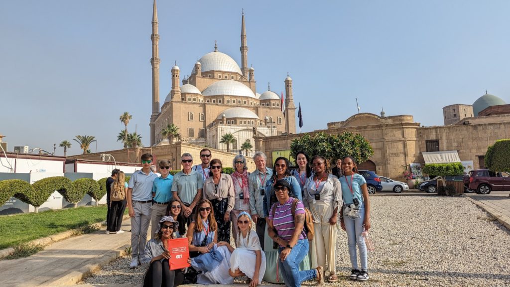 Our Trafalgar Egypt Tour group poses with guide Amira Hosny at the Hassan Mosque in Cairo.