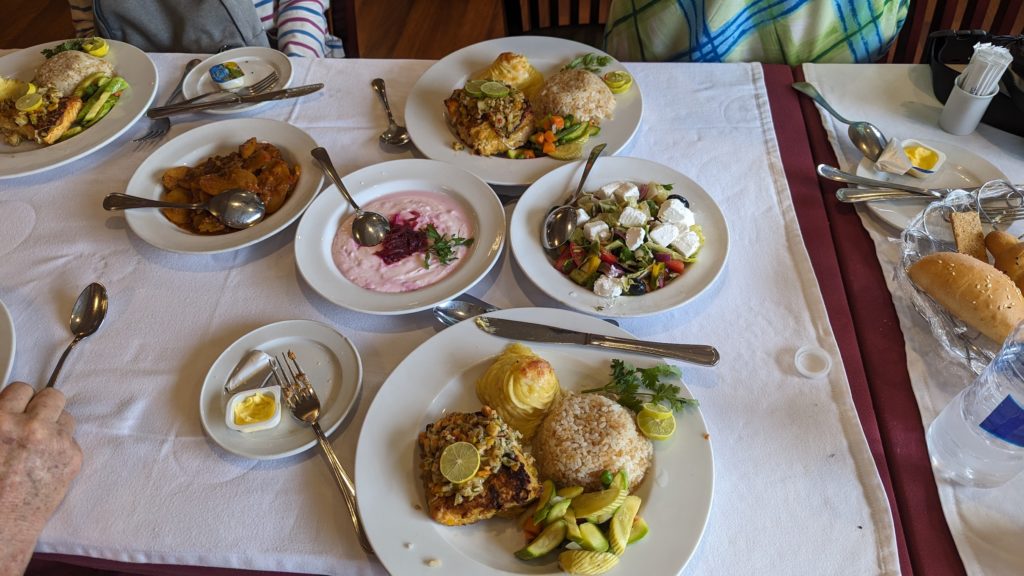 Roast chicken served with Egyptian specialties such as rice with vermicelli, vegetable dips, fresh salad and pickles for lunch on a Nile cruise.