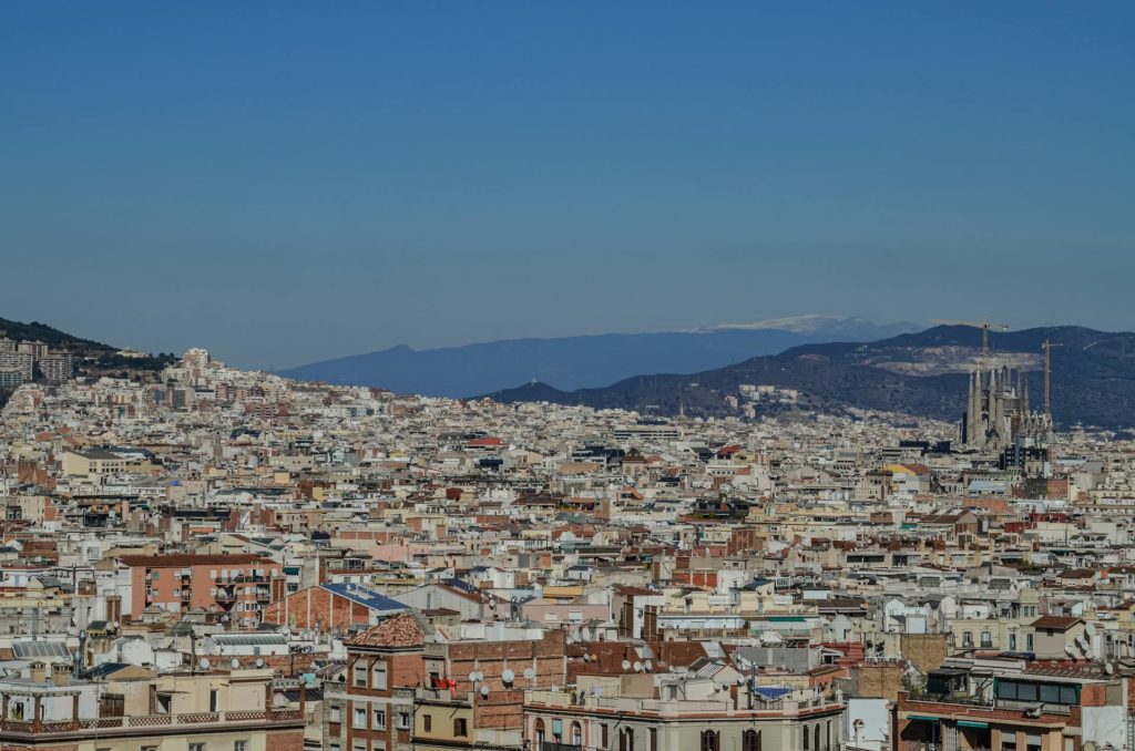 Aerial view of the old city of Barcelona with the Sagrada Familia cathedral at right. Photo c. HUB Jacque for pexels.