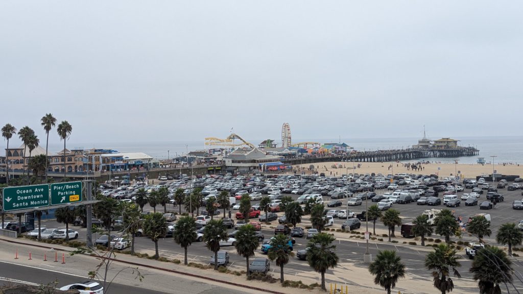 Aerial view of the Santa Monica beach and Pacific Park, the small amusement park on the historic Santa Monica pier in Los Angeles.