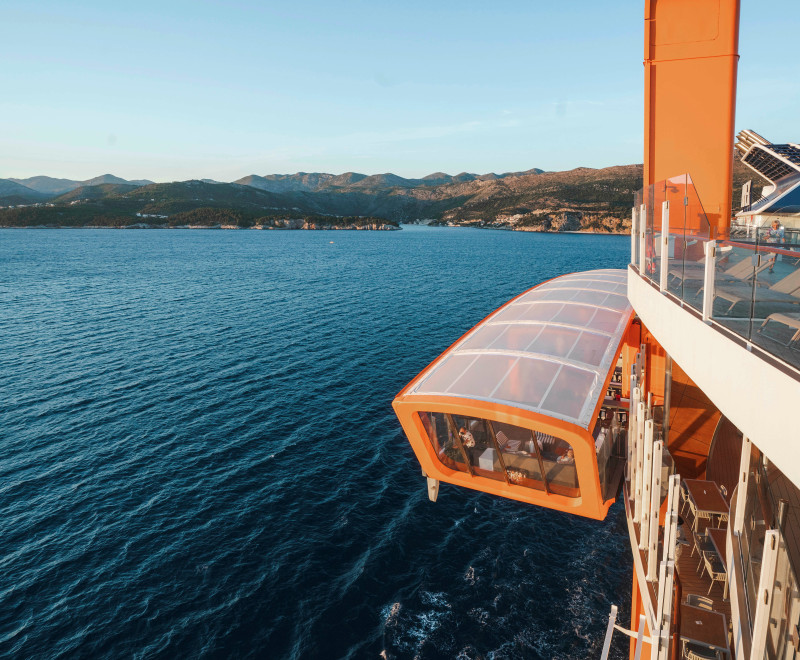 The Magic Carpet restaurant suspended over the deck of the Celebrity Apex cruise ship. Photo c. Celebrity Cruises