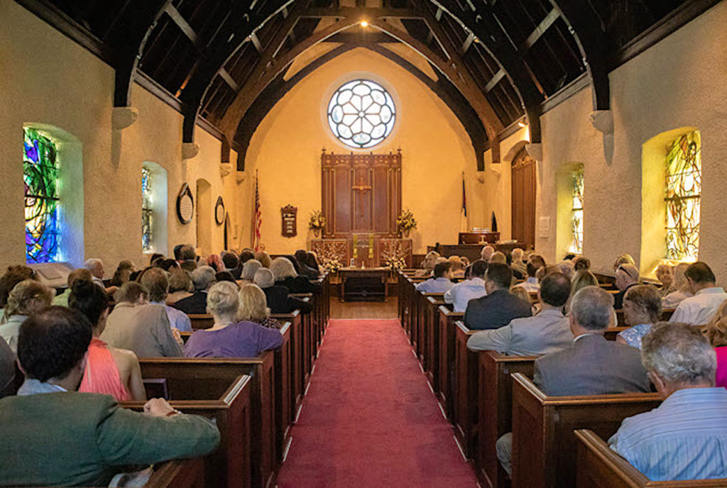 Congregation in the shadow of beautiful stained glass windows at the Union Church of Pocantico Hills. Photo c. Union Church