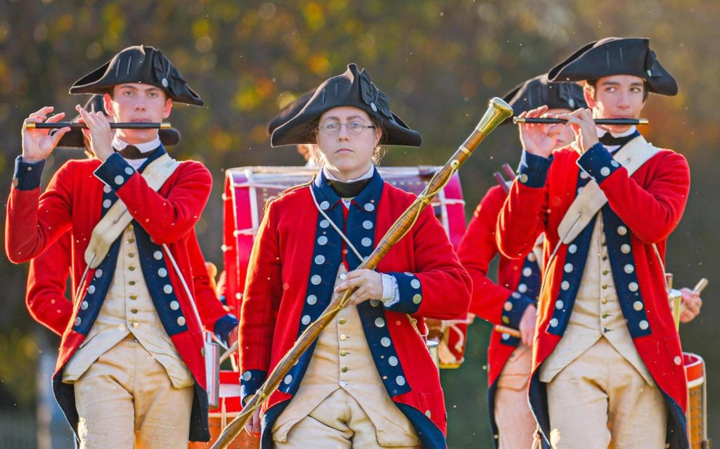 Uniformed marching band parades the grounds at Colonial Williamsburg. Photo c. pixels.