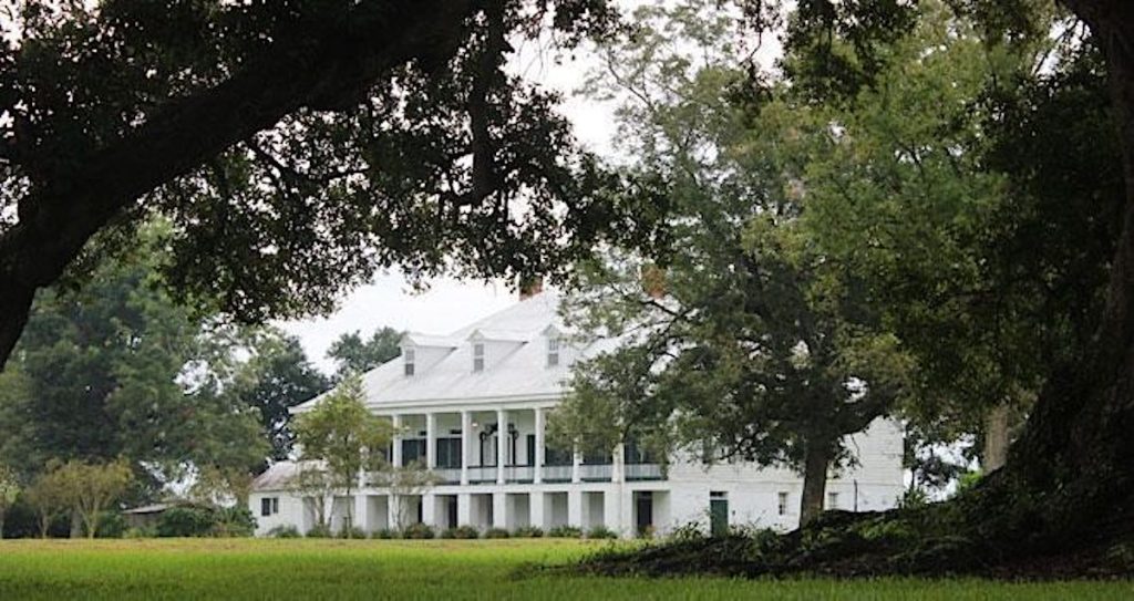 The classic white facade of St. Joseph's Plantation on Great River Road.