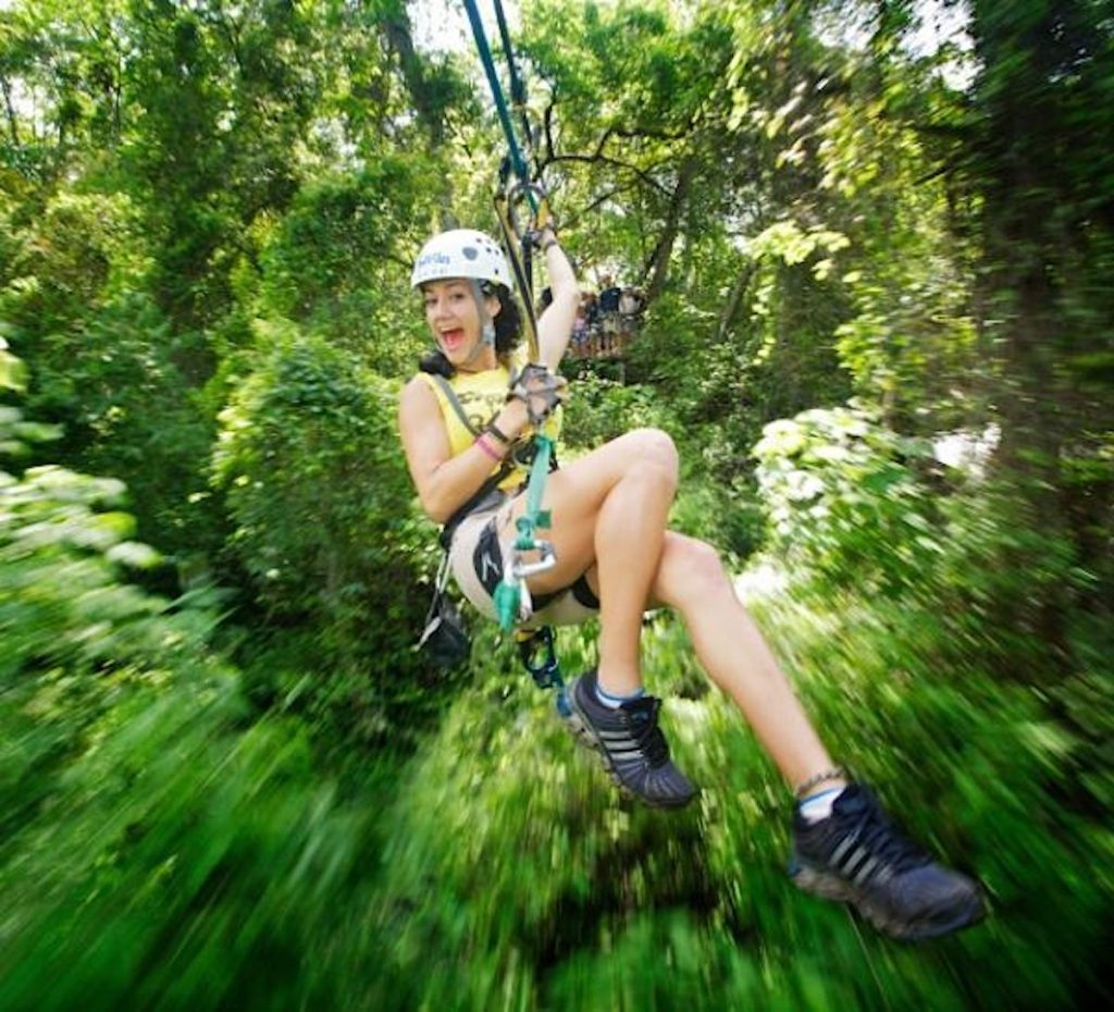 Girl on a zip line canopy tour in Mexico