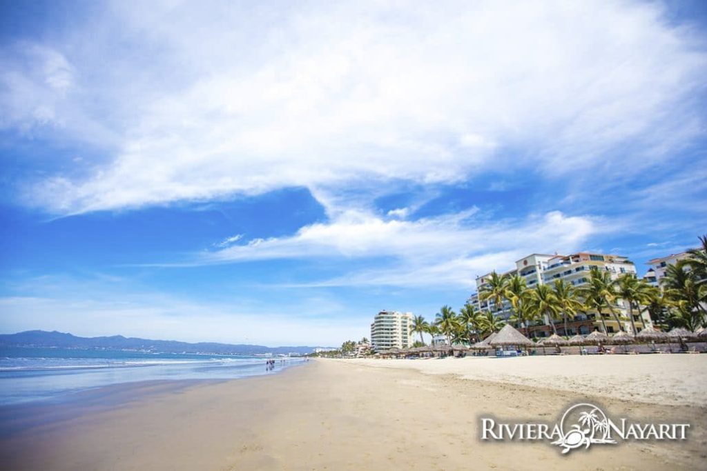 The broad sand beach at Nuevo Vallarta is lined with resorts. Photo c. Riviera Nayarit Tourism.