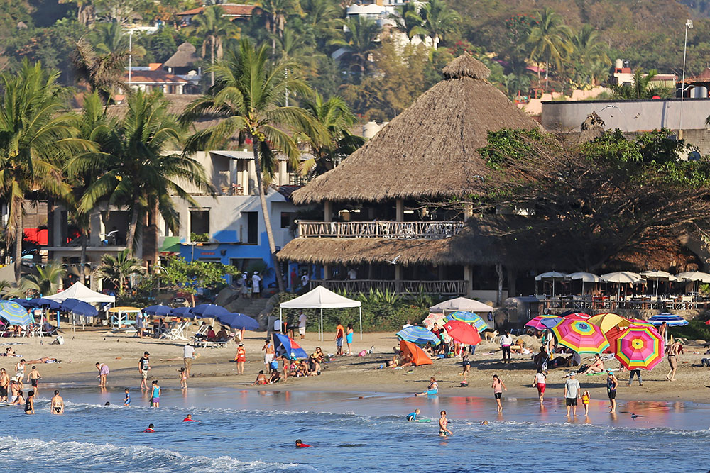 Don Pedro's thatch-roof restaurant is the heart of the popular surfers' beach at Sayulita, Mexico.