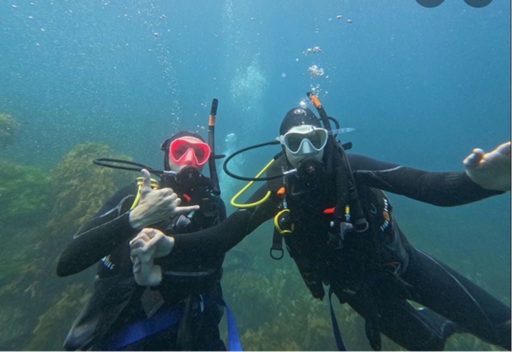 A mother-daughter moment below Poor Knights Islands, New Zealand, while on a family diving trip. Photo c. Ashley Spencer.