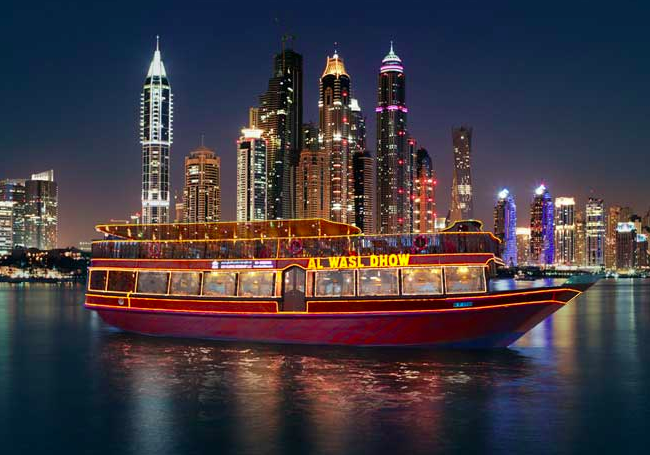 traditional dhows cruise the Dubai harbor