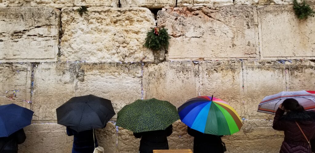 Visitors come to the Western Wall to pray and place notes inside the wall's cracks