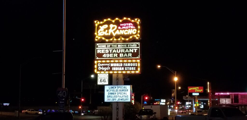 The flashing neon sign of the El Rancho Hotel Motel