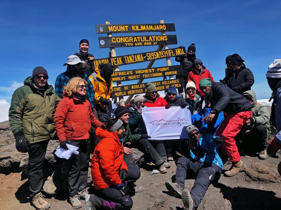 Explorers Passage trekking group reaches summit of Kilimanjaro, Africa's tallest peak.