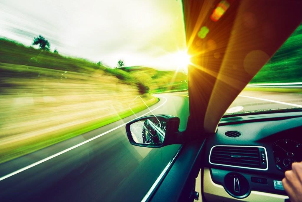 Rear view mirror view down highway