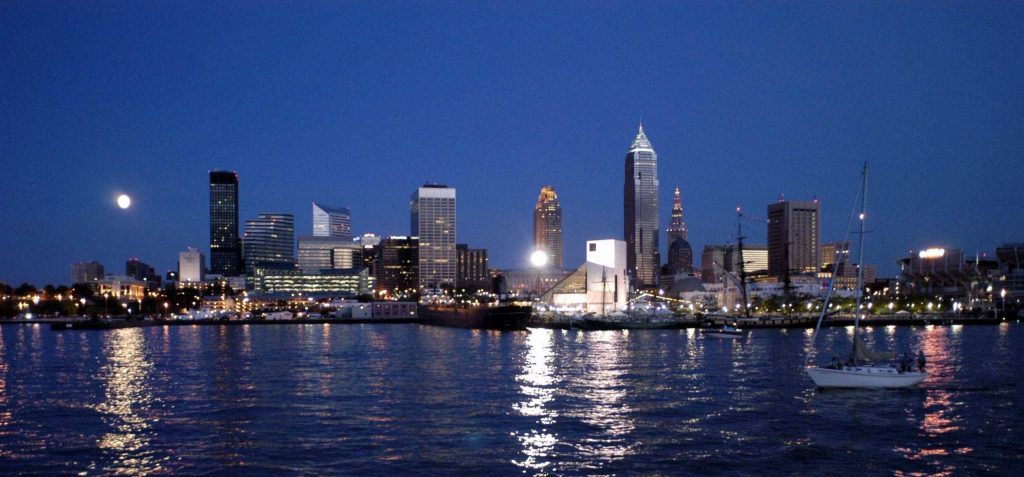 Cleveland at night, glowing above the Lake Erie shore.