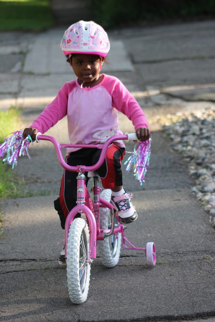 girl on bike with helmet
