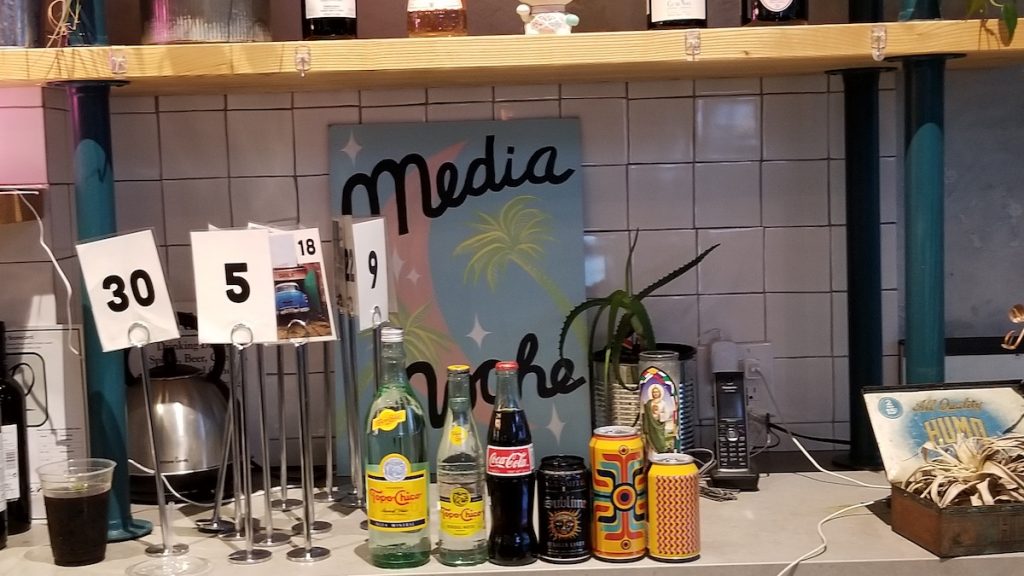 Variety of beverages on the counter in a Japanese izakaya bar.