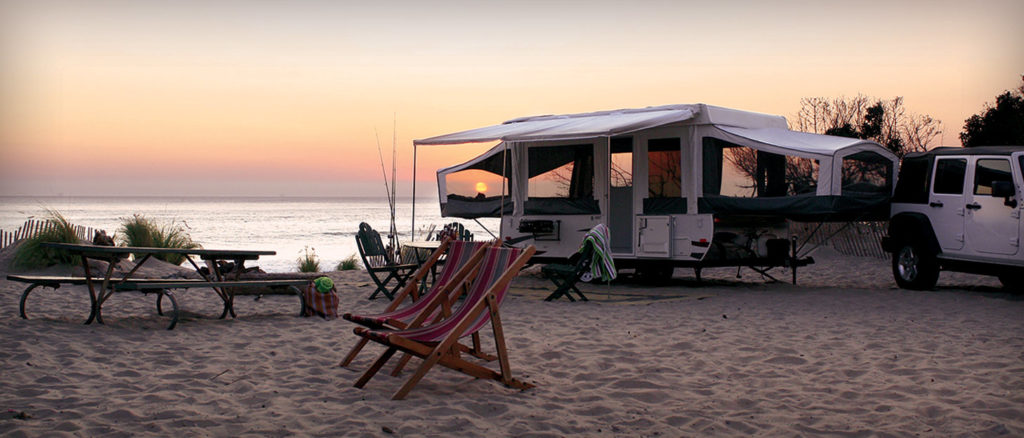 Pop Up Camper Trailer parked by the beach.
