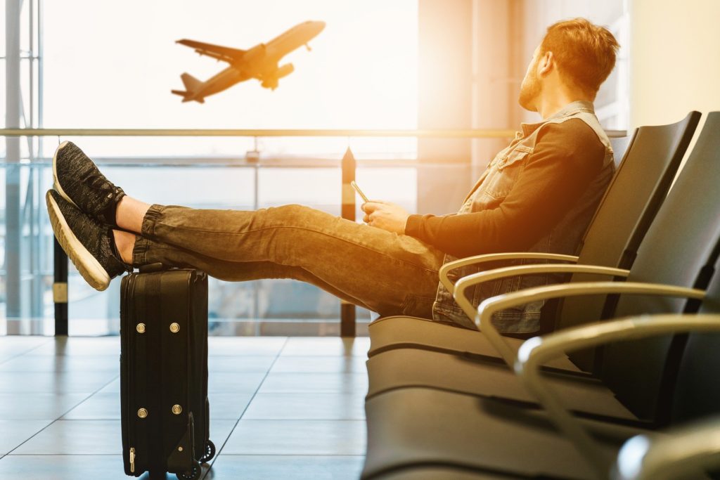 Passenger waiting at airport lounge by himself.