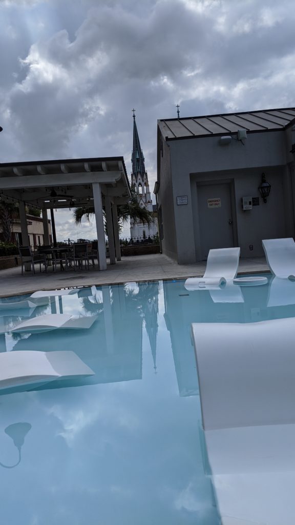 Stylish hotel pool deck at dusk.