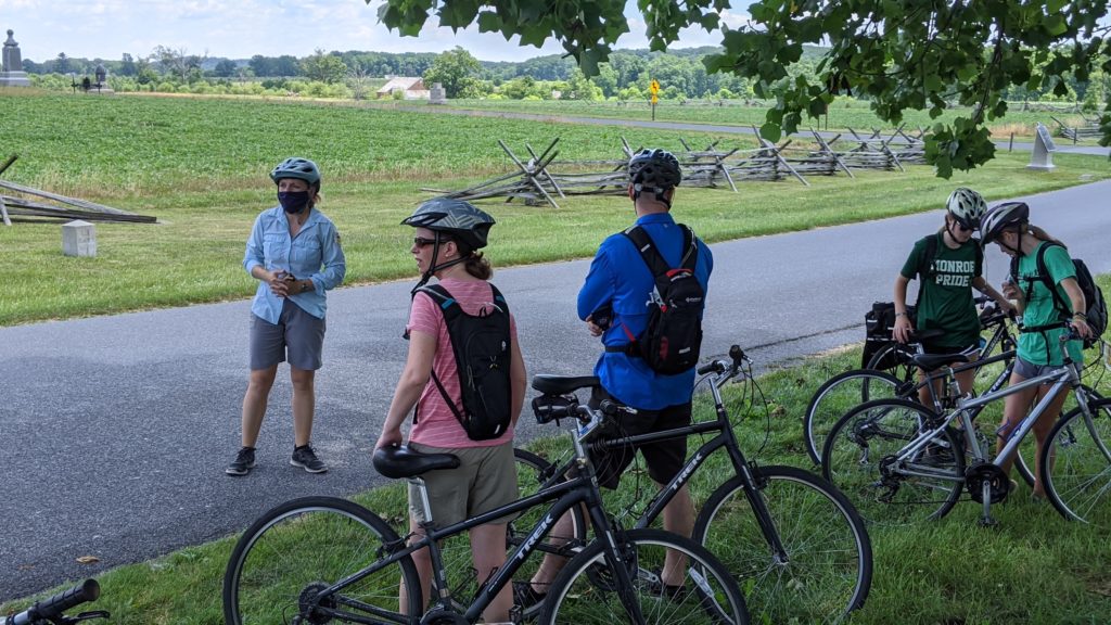 Guide Jessie and GettysBike Tour stops to talk about a battlefield at Gettysburg.