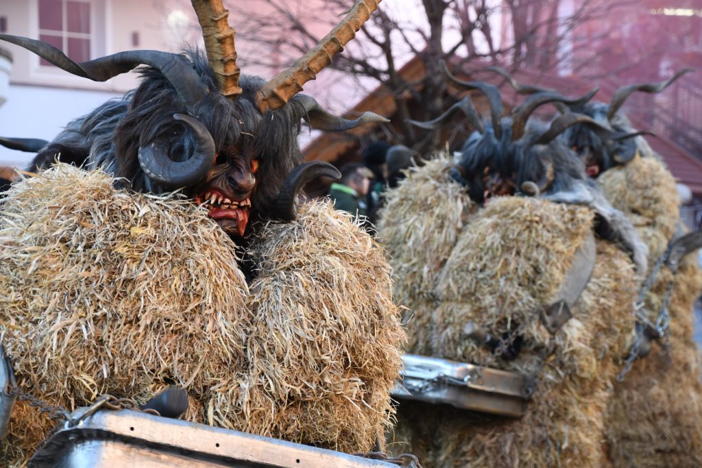 Scary Krampus figures in hay costumes parade through a Tyrol town in Austria.