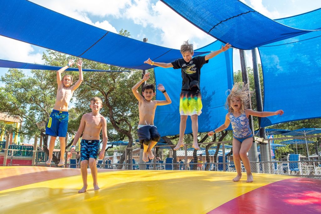 Kids bounce on a jumping pillow at the Jellystone Park Camp Resort at Canyon Lake, in the Texas Hill Country.