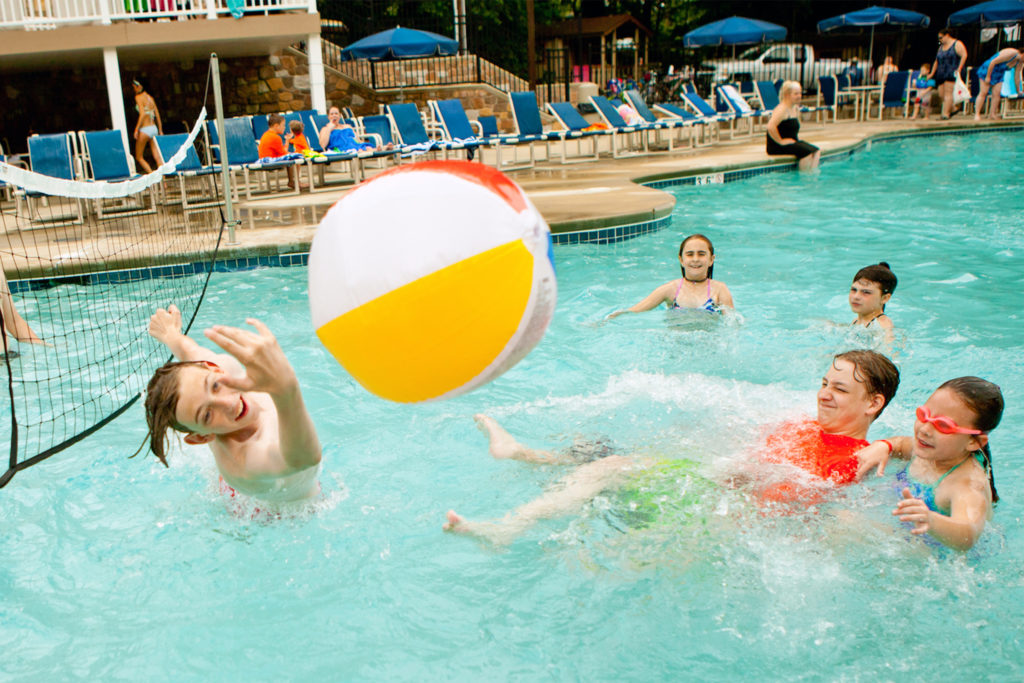 Several kids play pool volleyball at Jellystone Park campground in Quarryville, Pennsylvania.
