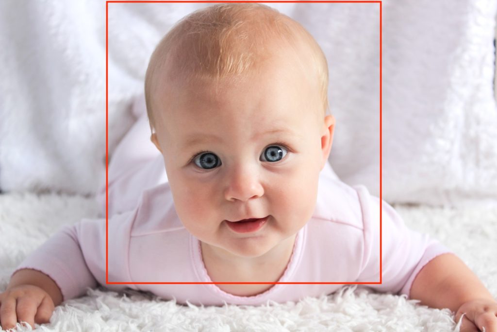 baby lying down on white fuzzy blanket