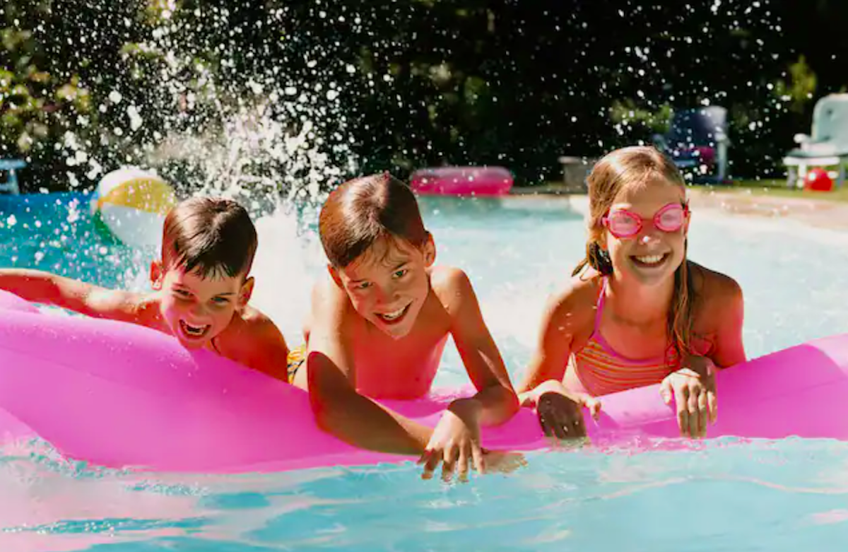 3 kids on floaties in a hotel pool at Southcape Wyndham Resort