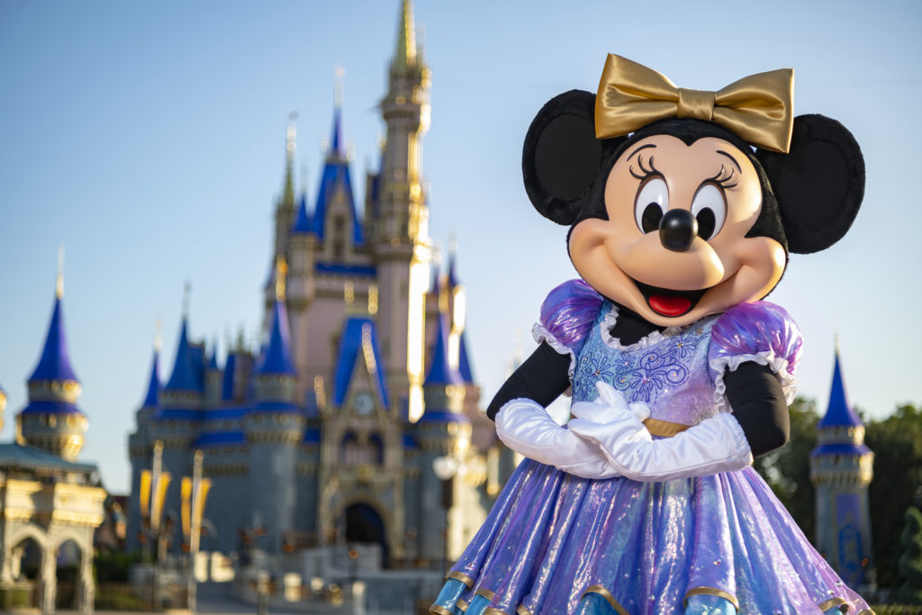 Minnie Mouse is in her sparkling new look, highlighted by embroidered impressions of Cinderella Castle on multi-toned, EARidescent fabric punctuated with pops of gold.