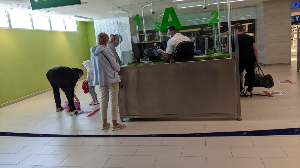 Multigenerational travelers go through Immigration and show proof of Covid vaccine at PUJ Punta Cana Airport.